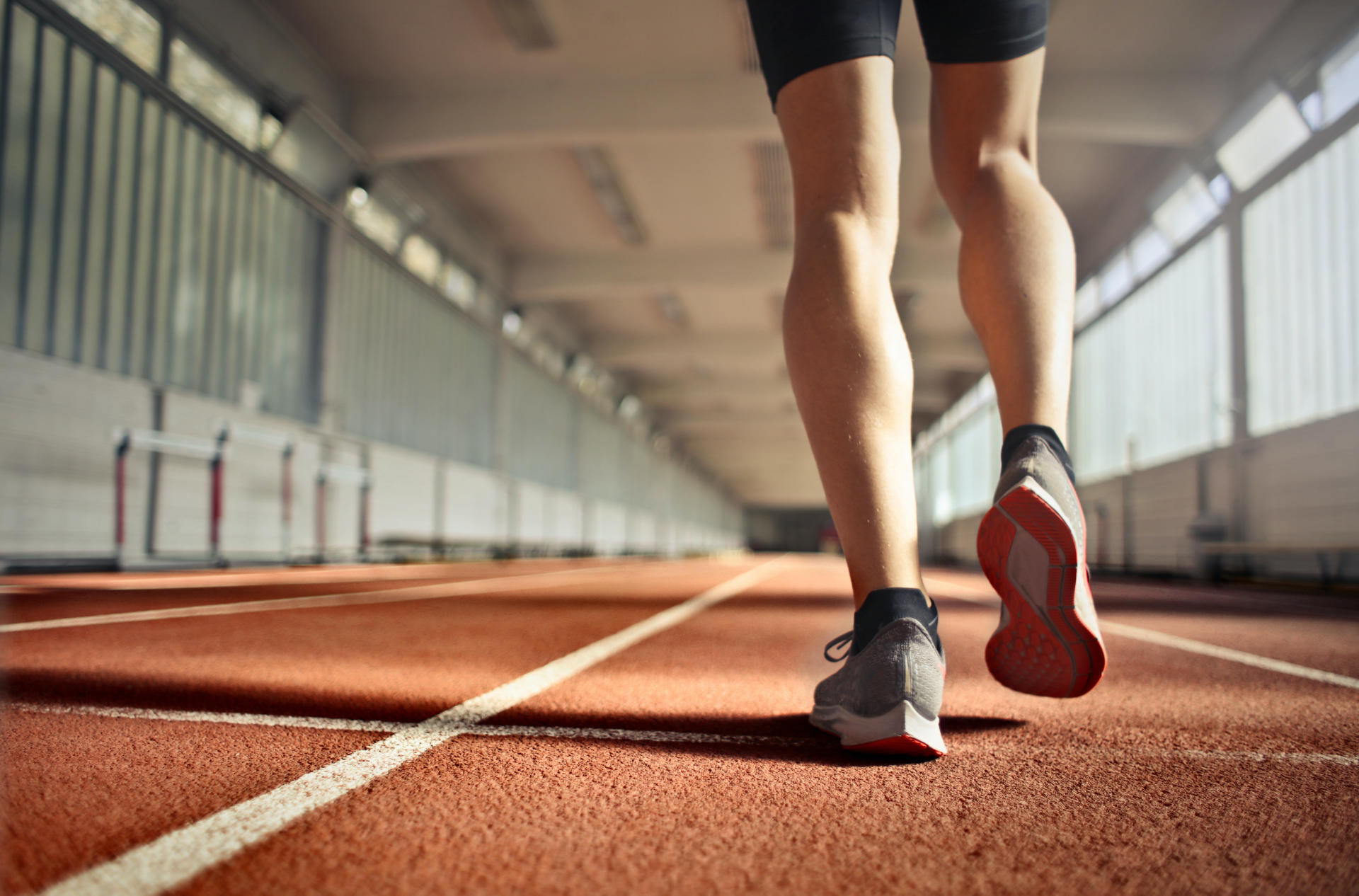 legs of a man running on a track